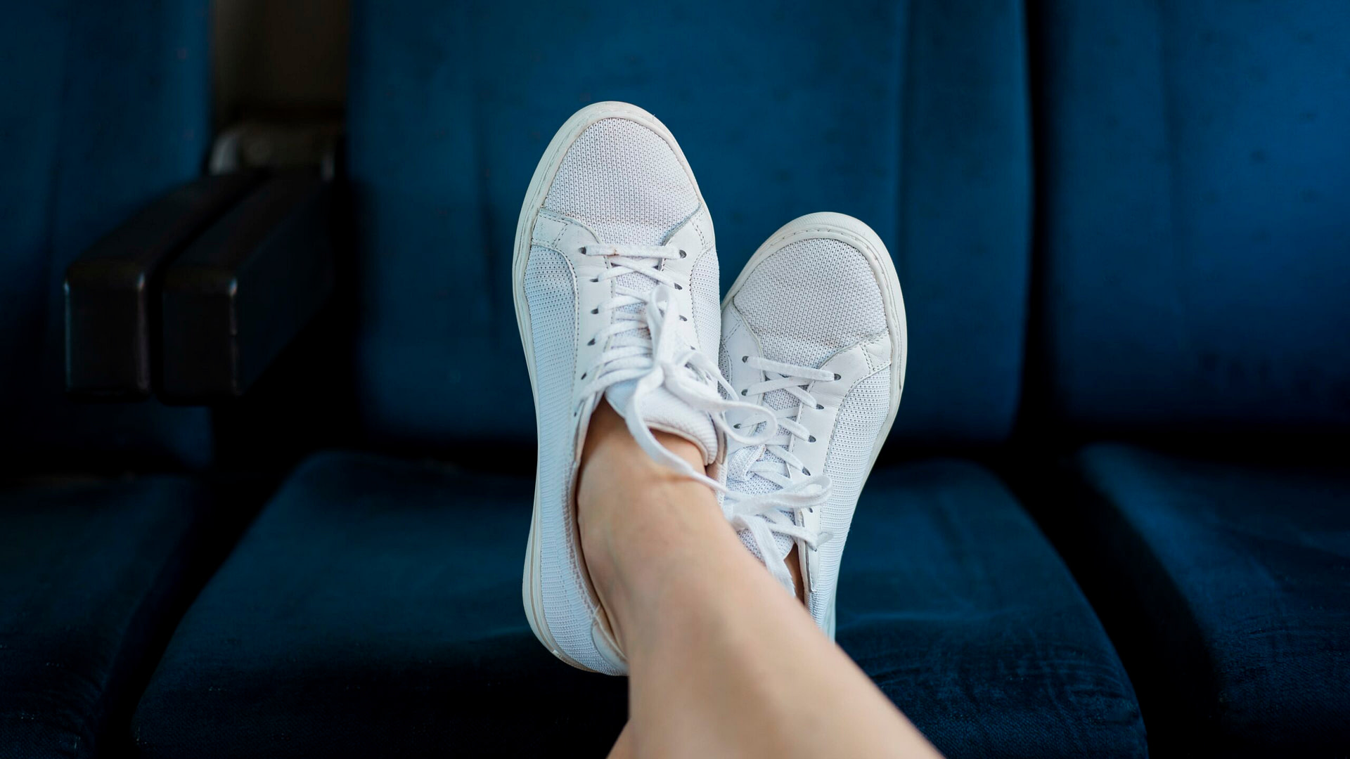 a pair of feet wearing blue shoes