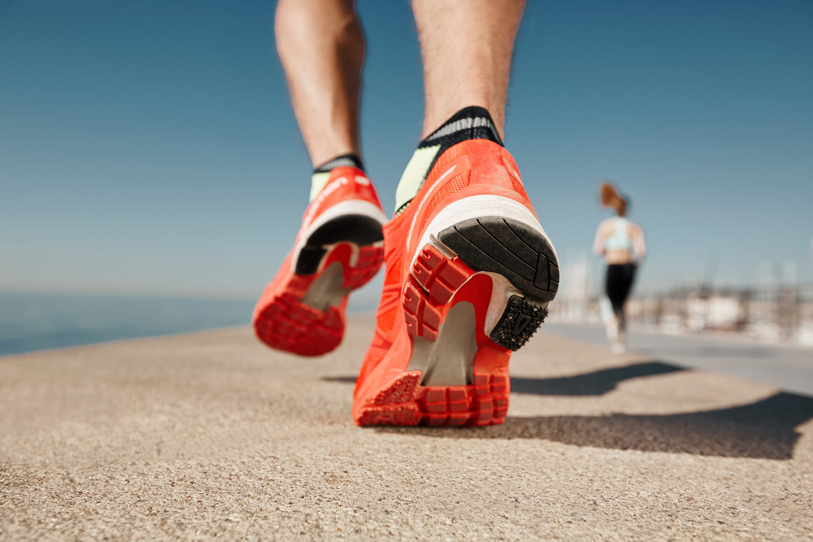 Close Up Runner Feet. Man Runner Legs And Shoes In Action On Roa